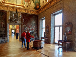 people walking through an old castle