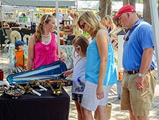 people looking at antiques at an outdoor show on the Golden Isles of Georgia
