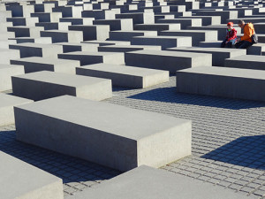 a couple sitting by a large memorial