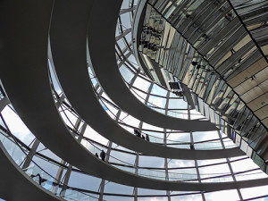 people on ramps inside a large glass dome