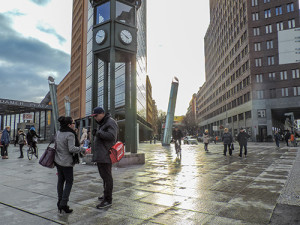 peopel on a city street with modern buildings