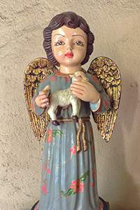 statue of an angel holding a lamb