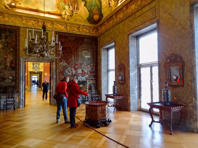 people walking through an old castle in Berlin