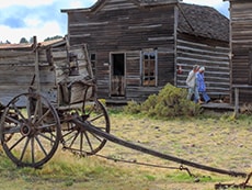 a wagon and old building in a ghost town