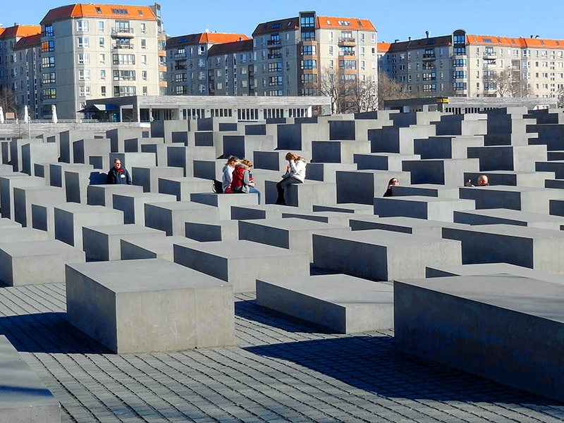 a couple sitting by a large memorial