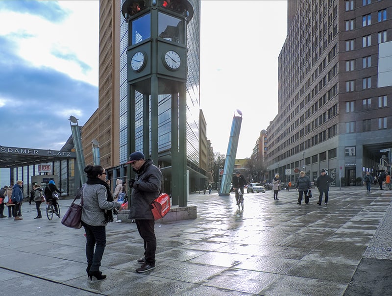 people on a city street with modern buildings