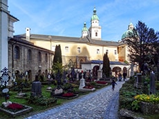 a cemetery near a large Baroque building