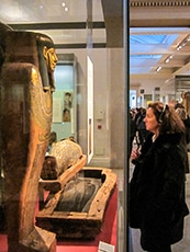woman looking at a mummy in a museum in London's West End
