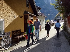 a couple walking along a street in a mountain town