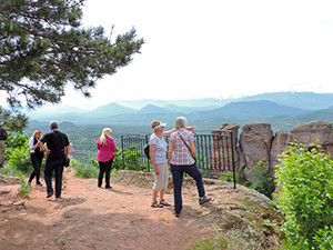 people on a hilltop looking across a valley