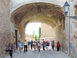 a group walking through a tunnel in an old city