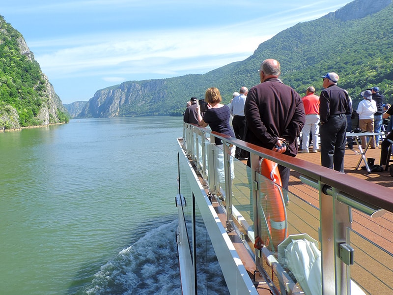 people on deck of a ship on a river cruise in Eastern Europe