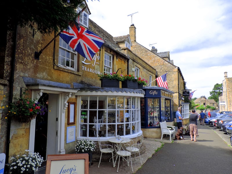 people walking along a street - one of the things to do in the Cotswolds