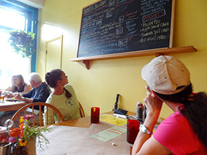 two women looking at on chalkboard menu