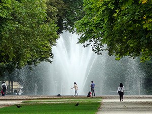 woman on a path near a park fountain in Brussels