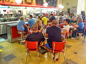 people sitting in a luncehonette