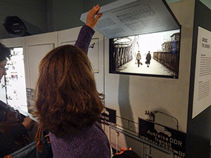 woman looking at an old photo exhibit