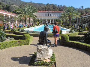 people looking at a pool and formal garden