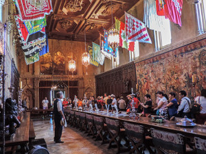 a wood-paneled room with flags hanging