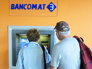 Mature travelers at an ATM overseas