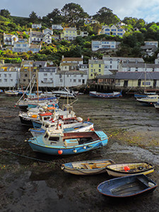 boats in mud at low tide in Polperro, one of the places to visit in Cornwall