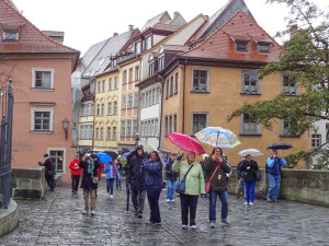 a grouip of mature travelerss walking through a European town 