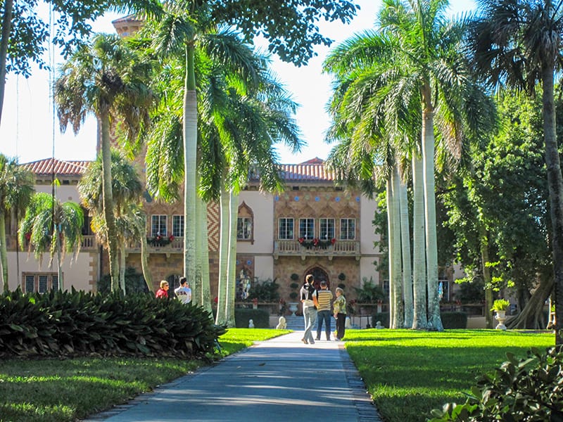 People in front of a historic home