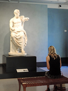 woman looking at an ancient statue