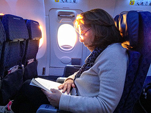 woman reading on a plane