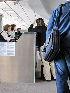 a woman at a airline ticket counter - passengers should know how to be compensated for a delayed flight
