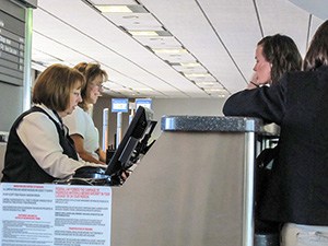 a woman at a ticket counter passengers should know how to be compensated for a delayed flight