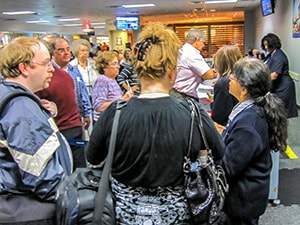 a crowd being told of a delayed flight - passengers should know how to be compensated for a delayed flight
