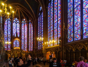 people looking at stained-glass windows