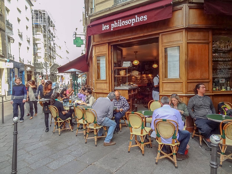 people at a cafe in the Marais, one of the top 10 places in Paris