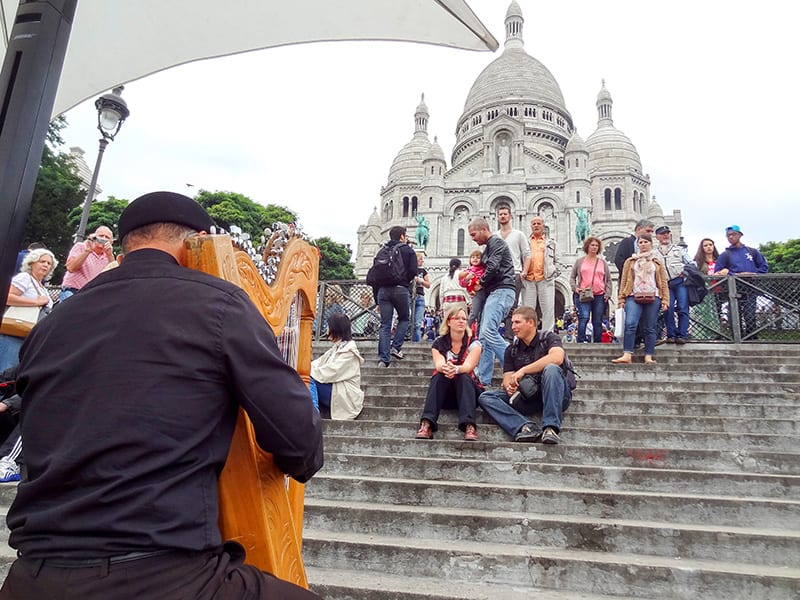 a harpist in front of Sacre-Coeur, one of the top 10 places in Paris