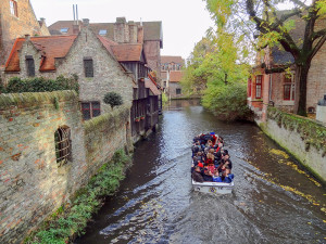 people on a European trip in a canal boat in Bruges