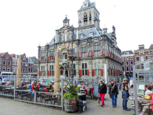 people walking by an ornate old building