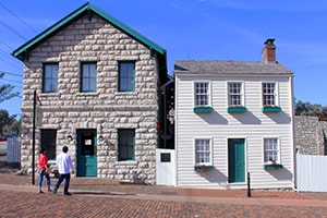 people in front of old buildings along the Mississippi River