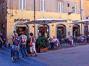 people walking by cafes in Lucca Italy