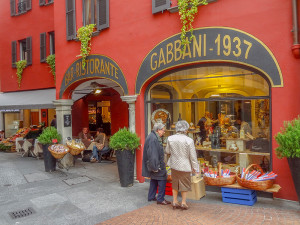 people on a European trip looking in a shop window