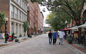 people on a street in a city along the Mississippi River