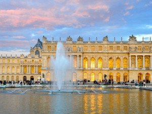 a fountain by an old-world building seen on a European trip