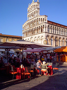 people at cafe tables in Lucca, Italy