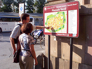 people looking at a mapin Lucca, Italy