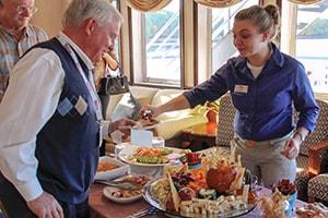 people being served food aboard Queen of the Mississippi