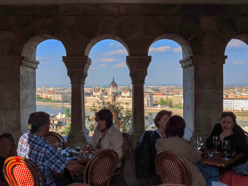 people having drinks in a afe by a river, seen during 2 days in Budapest