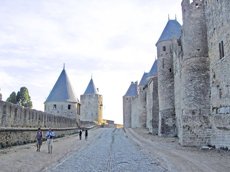 people walking along the walls of a castle in Languedoc-Roussillon