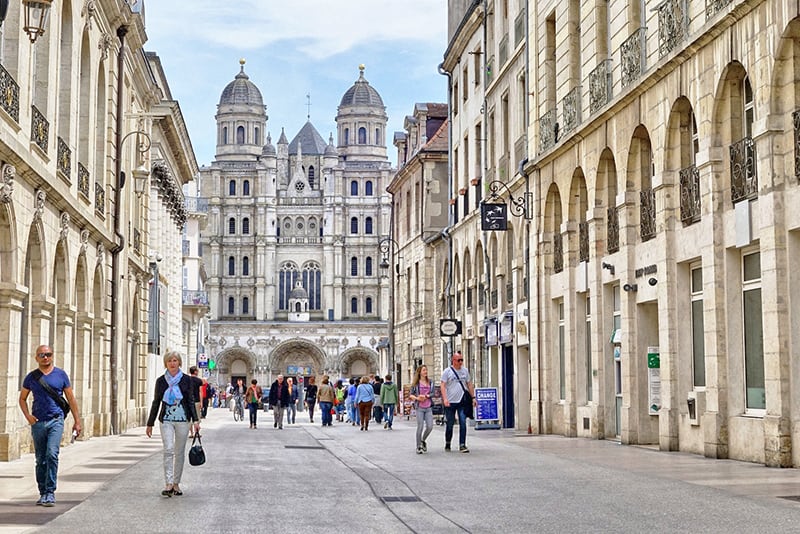 people walking in an old area of Dijon