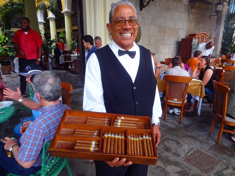 waiter with a box of cigars
