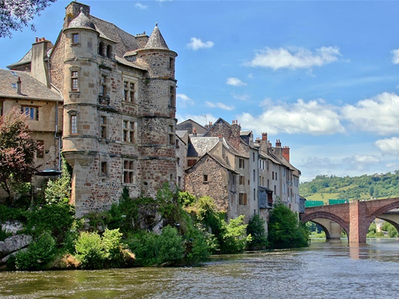 old stone building on a river in France's Midi-Pyrenees